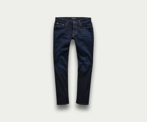 Een premium paar The N01 Slim Dark Indigo jeans van Blue Rivet Jeans, met een slim fit die plat ligt tegen een lichte achtergrond. Deze stijlvolle jeans hebben een klassiek five-pocket design, zichtbare stiksels en een vleugje stretch voor extra comfort.