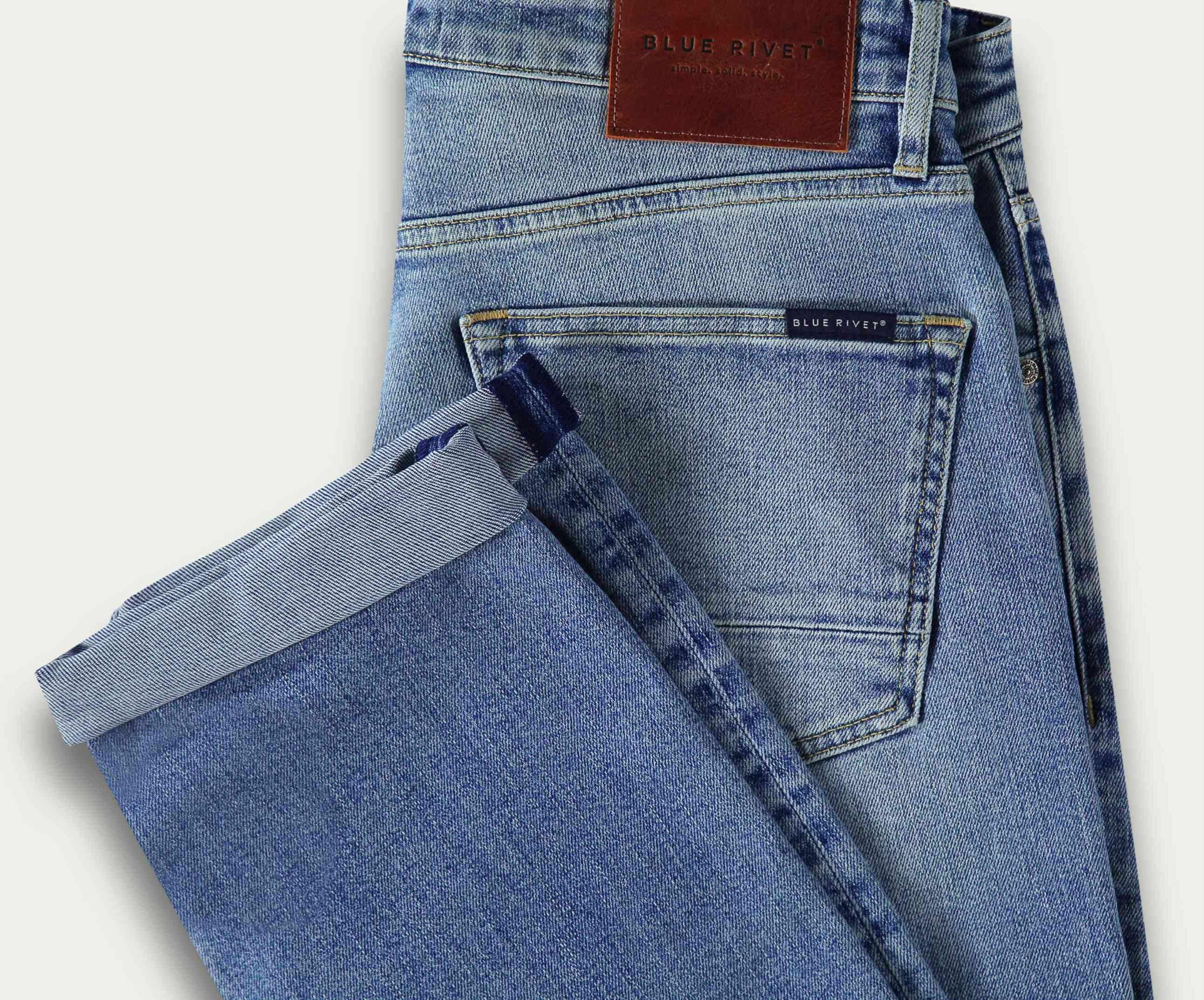 De N01 Straight Stone Bleached blue jeans van Blue Rivet Jeans heeft een leren patch met de merknaam op de tailleband. Dit denimontwerp heeft een zichtbare achterzak, lichtblauwe stof met subtiele vervaging en één pijp gedeeltelijk opgerold.