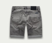 De achterkant van "The N01 Short Light Grey Used" van Blue Rivet Jeans toont een paar grijze denim shorts met opgerolde zomen. Deze shorts, ook wel "korte broek" genoemd, hebben twee achterzakken en een zwart taillebandlabel. De licht vervaagde stof versterkt hun casual, versleten uiterlijk.